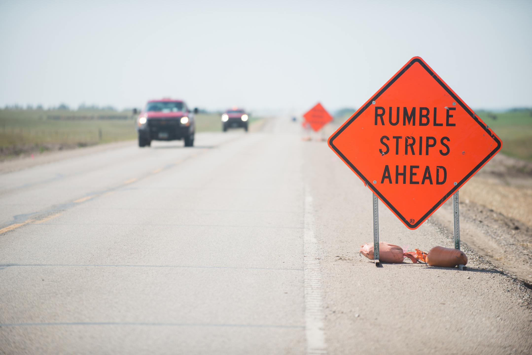 Orange road sign: "Rumble Strips Ahead"